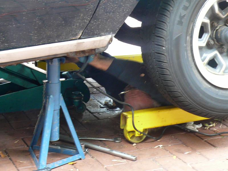 P1170787.JPG - Grinding out the exhaust crossover bolts.