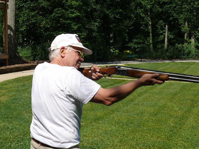 P1160894.JPG - No, Win's not shooting the ground.  He's lining up with the post in the center of the range.  The clay will fly about 15 feet directly above the post.