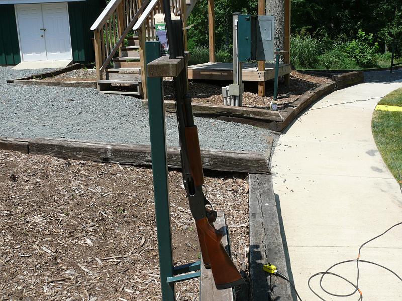 P1160923.JPG - Each station has a gun rack.  The yellow thing atached to the wire is used to trigger the machines that throw the clays.  It has a high house button, a low hous button and a doubles button.  The doubles button throws from both house simultaneously.